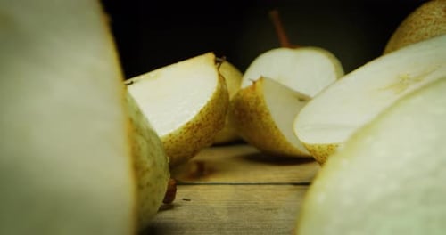 super macro slide shot of pears on a wooden bench, in slow motion. Concept: food, fruit, nature