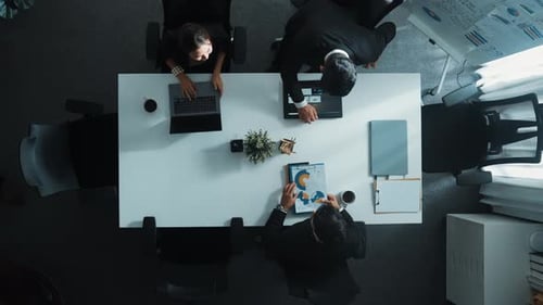 Top view of smart team walk at meeting table and start to discuss. Directorate.