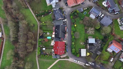 Luxury homes with solar panels in suburb district of american town. Car on street near agricultural