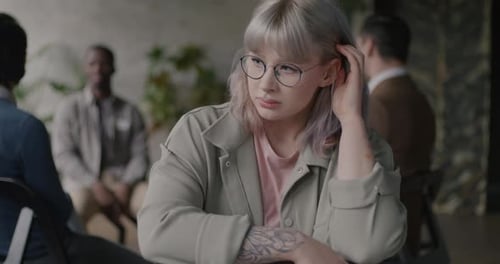 Contemplative Woman Attending a Support Group
