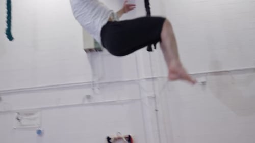 Male Acrobatics on Trampoline in Bright Gym