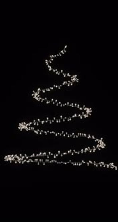 Christmas tree made of garlands and glowing particles on a transparent background, alpha channel.
