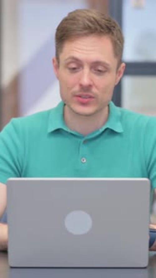 Adult Man Video Conferencing on Laptop Computer