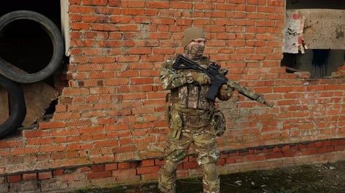 Man in camouflage uniform with rifle stands guard