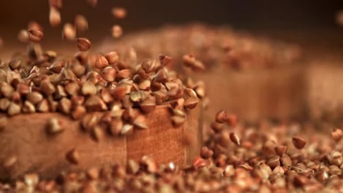 Buckwheat Falls Into a Wooden Plate Filmed on a Highspeed Camera at 1000 Fps