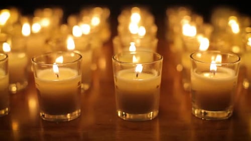 Rows of candles in a church or temple.