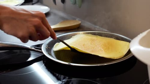 Cooking pancakes on the stove in a kitchen