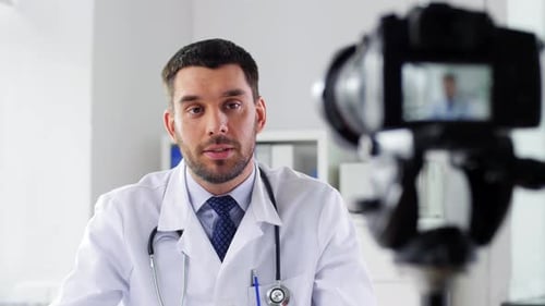 Healthcare Medicine and Blogging Concept - Male Doctor with Camera Recording Video