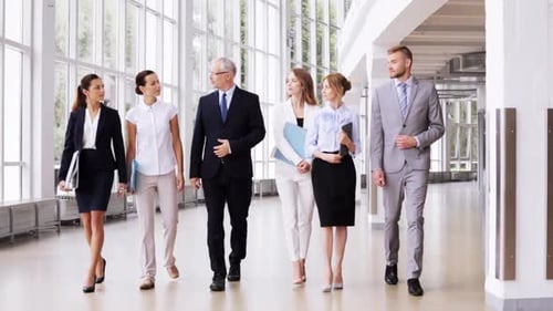 Diverse business team walking and talking near the office building