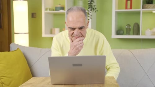 Senior Man Frustrated Using Laptop at Home