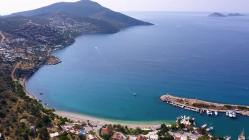 Aerial Drone View of Coastal Town with Green Mountains