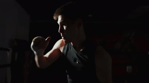 An Athlete is Engaged in a Shadow Battle in a Dark Gym Slow Motion Portrait of a Man of Kazakh