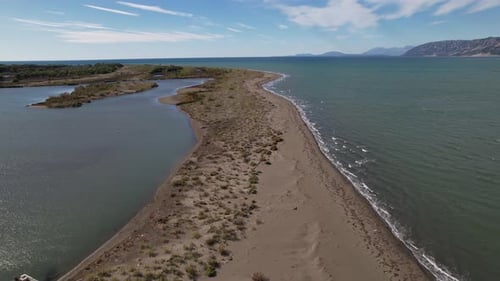 Sandbank separates the lagoon with shallow water from salty seawater in coastline of Albania, ideal