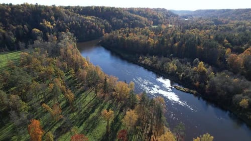 Autumn landscape view of a river surrounded by colorful foliage