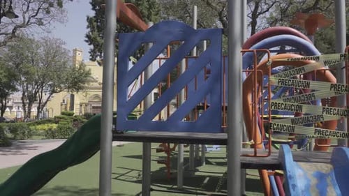 A closeup of a slide on a closed playground due to COVID-19 pandemic