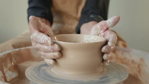 Close up of Unrecognizable Craftswoman Creating Small Bowl on Potters Wheel