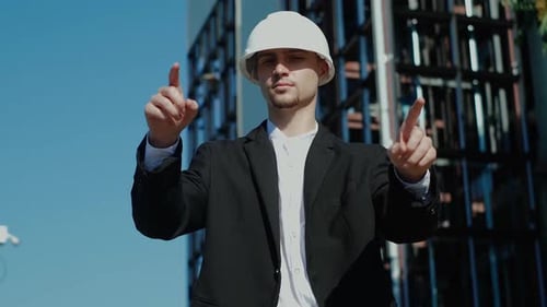 Architect Interacting with Digital Interface near Building