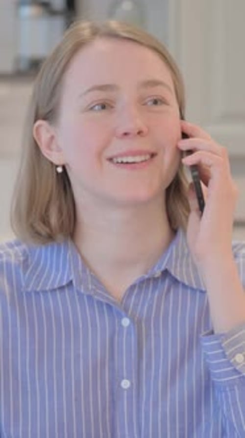 Young Woman Talking on Cell Phone in Home