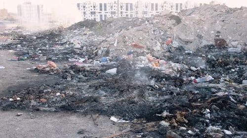 Urban Landfill with Burning Garbage and Waste