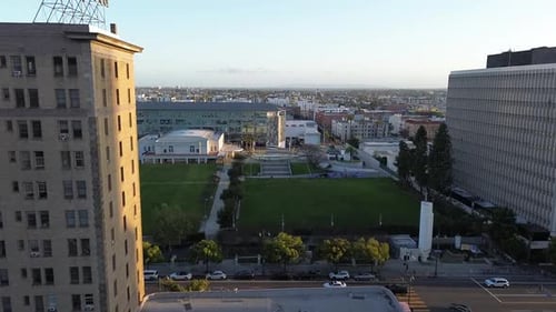 Push in drone shot of dense urban city neighborhood during sunset.