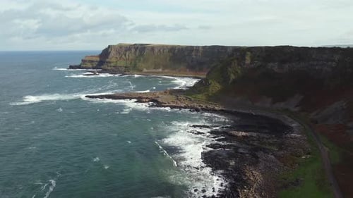 Aerial view of the Giant's Causeway on a sunny day, County Antrim, Northern Ireland. Flying away fro