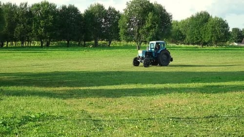 Blue Tractor Tractor Cultivating at Spring Agriculture Tractor Plowing Field Agronomy Farming