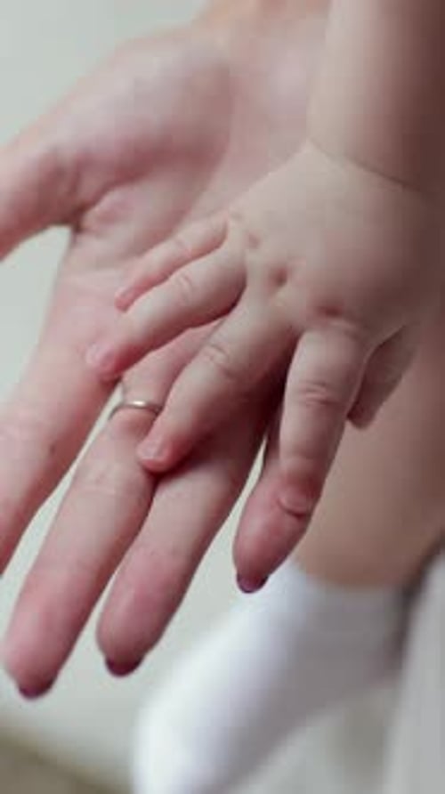 Hand of a Newborn Baby Hand in Mother Hand Vertical Video