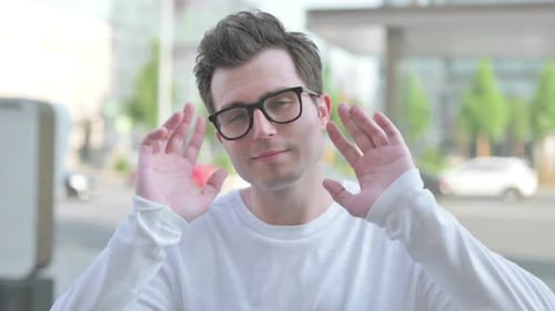 Adult Flexing Wrists and Wiggling Fingers Outdoors