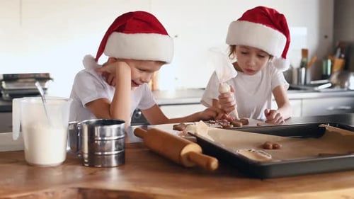 Children Decorating Christmas Gingerbread Cookies in Kitchen