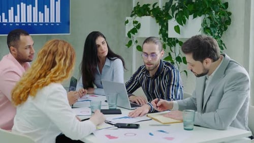 Team Meeting in an Office Conference Room Young Professionals Talking Sharing Ideas and