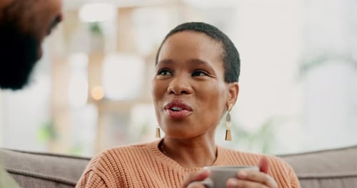 Woman Talking with Friend While Holding a Cup