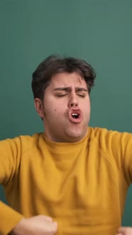Successful Man Shouting Joyfully in Green Studio