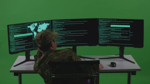Back View Of Bored Asian Man Soldier Developer Write Code With Multiple Screens In Green Screen