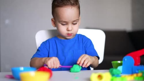 Boy Plays with Clay at Home