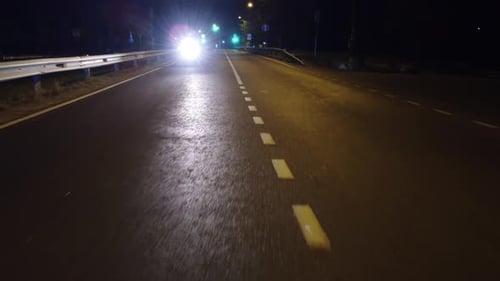 night road top view with a passing motorcycle