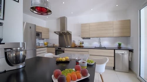 Panning shot of modern kitchen with fresh fruits on table,close up shot