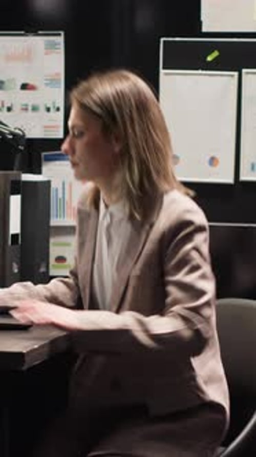 Businesswoman Reviews Data in Office Setting