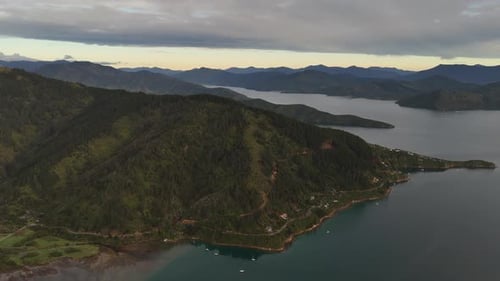 Aerial wide shot of sailing boats on Picton area with shoreline of town. Cook straight border