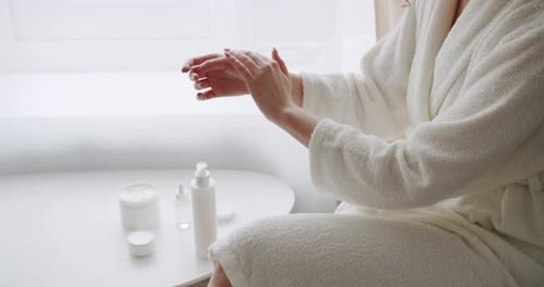 Spreading the Applied Moisturizing Hand Cream so That It Gets Soaked