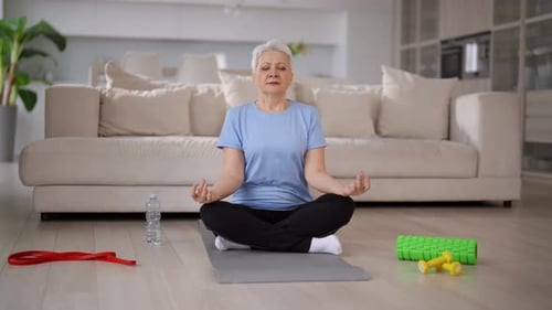 Senior Woman Meditating Peacefully at Home
