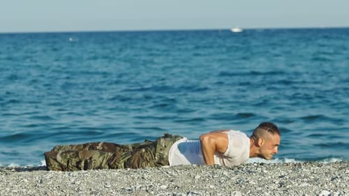 Soldier Does Push Ups on the Beach