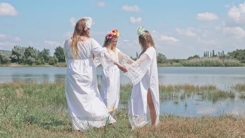 Women in White Dresses Dancing by Serene Lake
