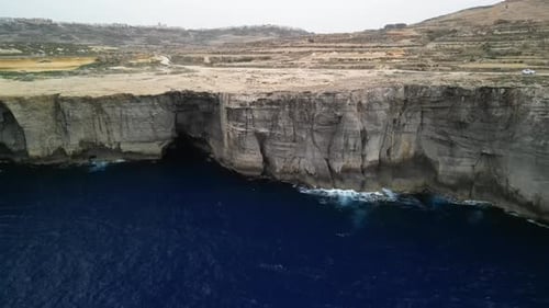 Aerial video over the island of Gozo, beautiful Malta cliffs from above