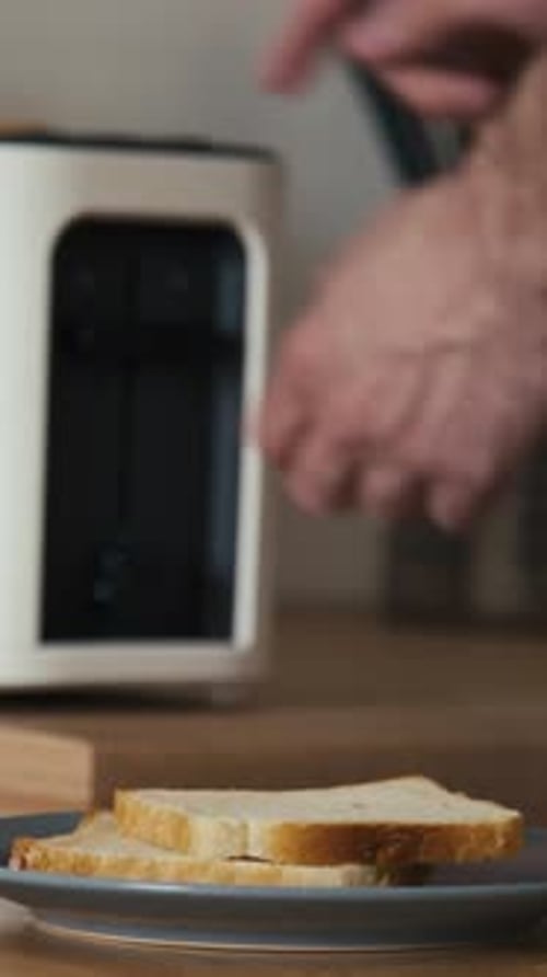 Hand stacking sliced bread on plate