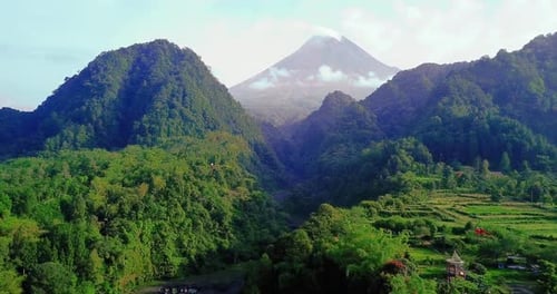 Merapi volcano with two hills overgrown with forest. Kaliurang, Indonesia.