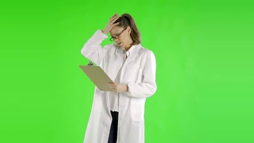 Woman Scientist Reviewing Clipboard Data in Lab Coat