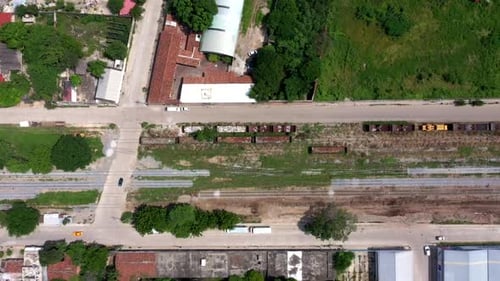 Aerial close-up view of the train tracks in the suburbs of the city of Oaxaca in Mexico, filmed by a
