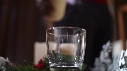 Front view shot of an African American man's hand pouring a traditional holiday drink Christmas eggn