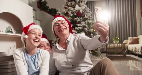 Woman Taking Christmas Selfie With Two Girls