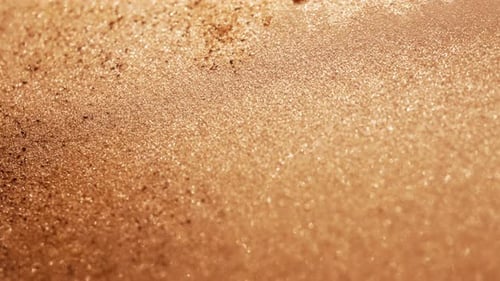 Wet Golden Sand Glistening in the Sunlight